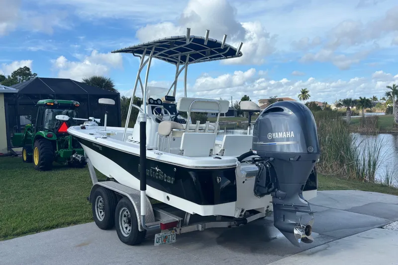 Slide: The Image of 2017 NauticStar 215 XTS Shallow Bay boat with Yamaha engine on trailer by a lake. - 9