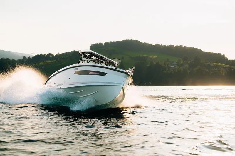 Slide: The Image of 2026 Navan S30 boat cruising on a scenic lake with hills in the background. - 10