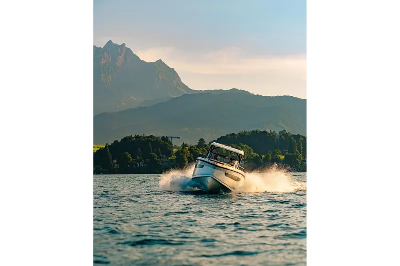 Slide: The Image of 2026 Navan S30 boat cruising on a scenic lake with mountains in the background. - 11