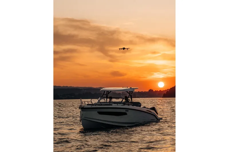 Slide: The Image of 2026 Navan S30 boat on water at sunset with drone flying above. - 18