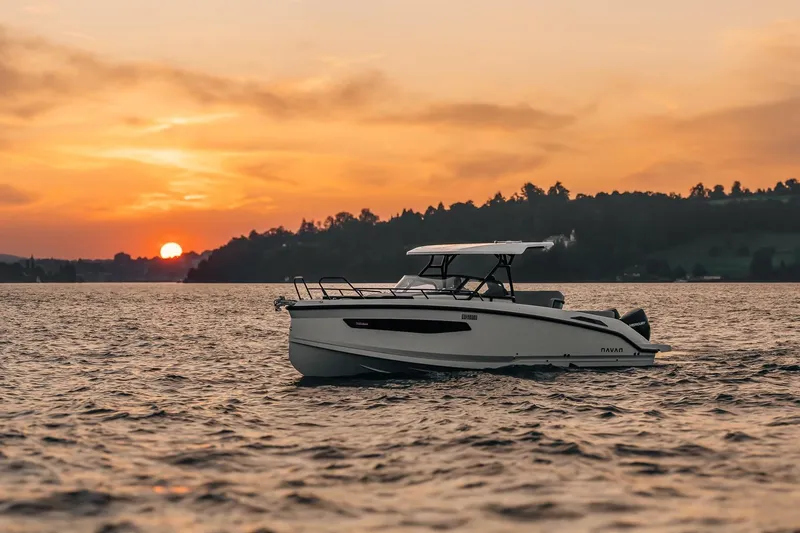 Slide: The Image of Navan S30 boat cruising at sunset on a serene lake, 2026 model. - 21