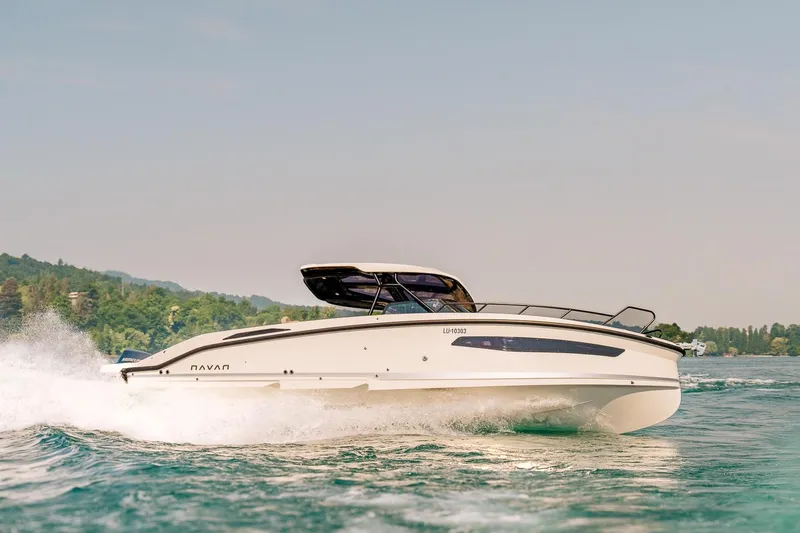 Slide: The Image of 2026 Navan S30 boat cruising on a scenic lake with lush greenery. - 26