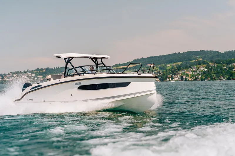 Slide: The Image of Navan S30 2026 boat cruising on a scenic lake with hills in the background. - 27