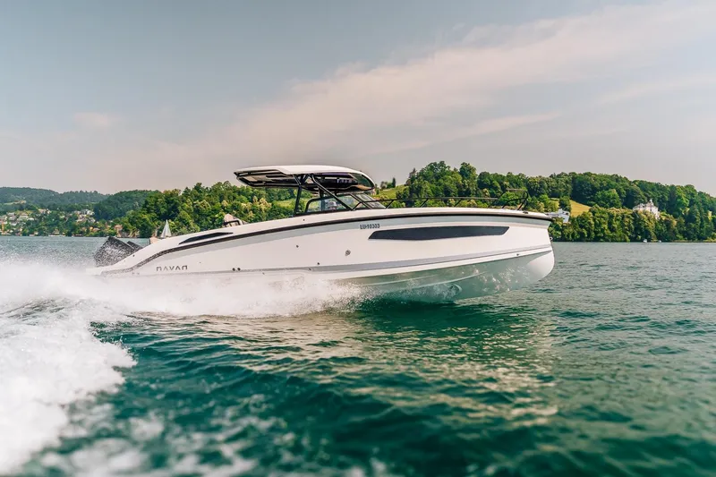 Slide: The Image of 2026 Navan S30 boat cruising on a scenic lake with lush green hills. - 28