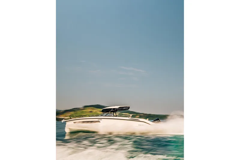 Slide: The Image of 2026 Navan S30 boat speeding on water with scenic background. - 30