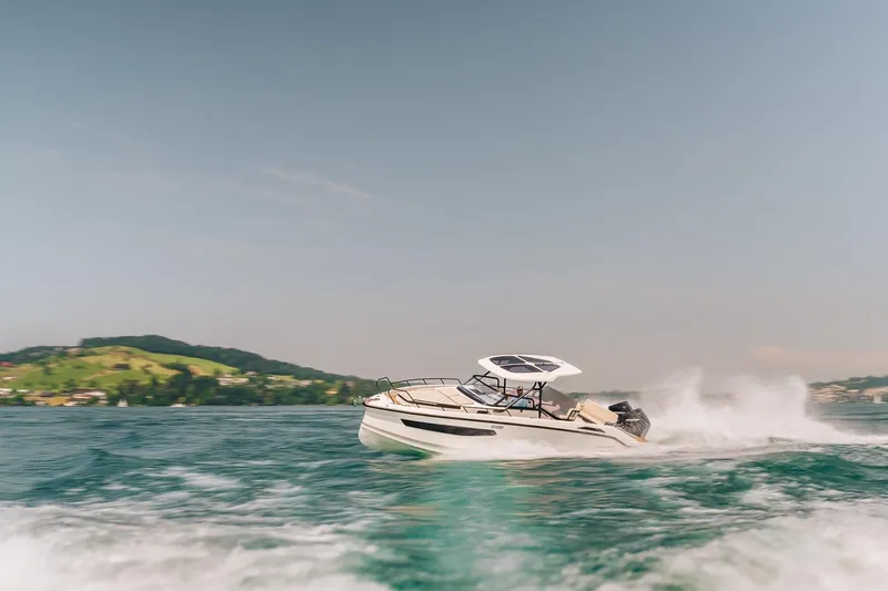 Slide: The Image of 2026 Navan S30 boat cruising on a scenic lake with hills in the background. - 31