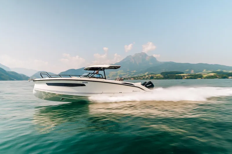 Slide: The Image of Navan S30 2026 speedboat cruising on a scenic lake with mountains in the background. - 34