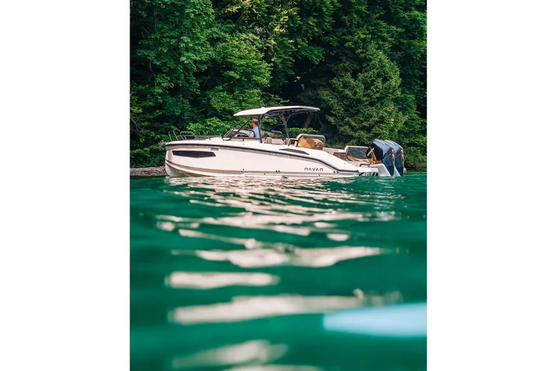 Slide: The Image of 2026 Navan S30 boat on serene green water, surrounded by lush trees. - 36