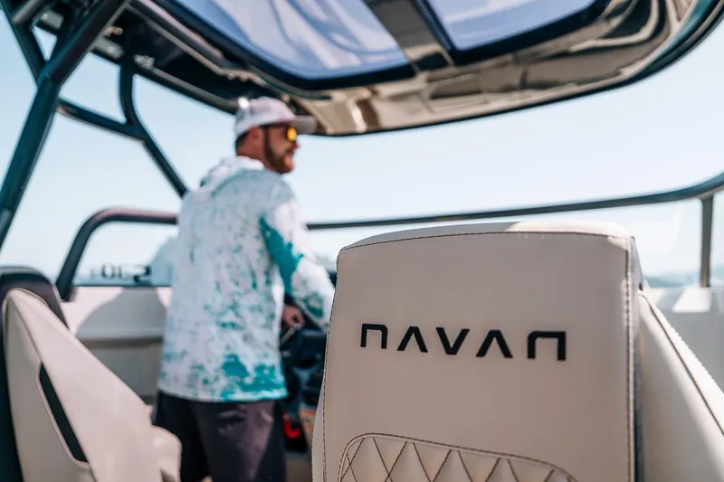 Slide: The Image of Man steering 2026 Navan S30 boat, focus on branded seat. - 40