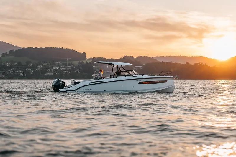 Slide: The Image of 2026 Navan S30 boat cruising on a serene lake at sunset. - 46