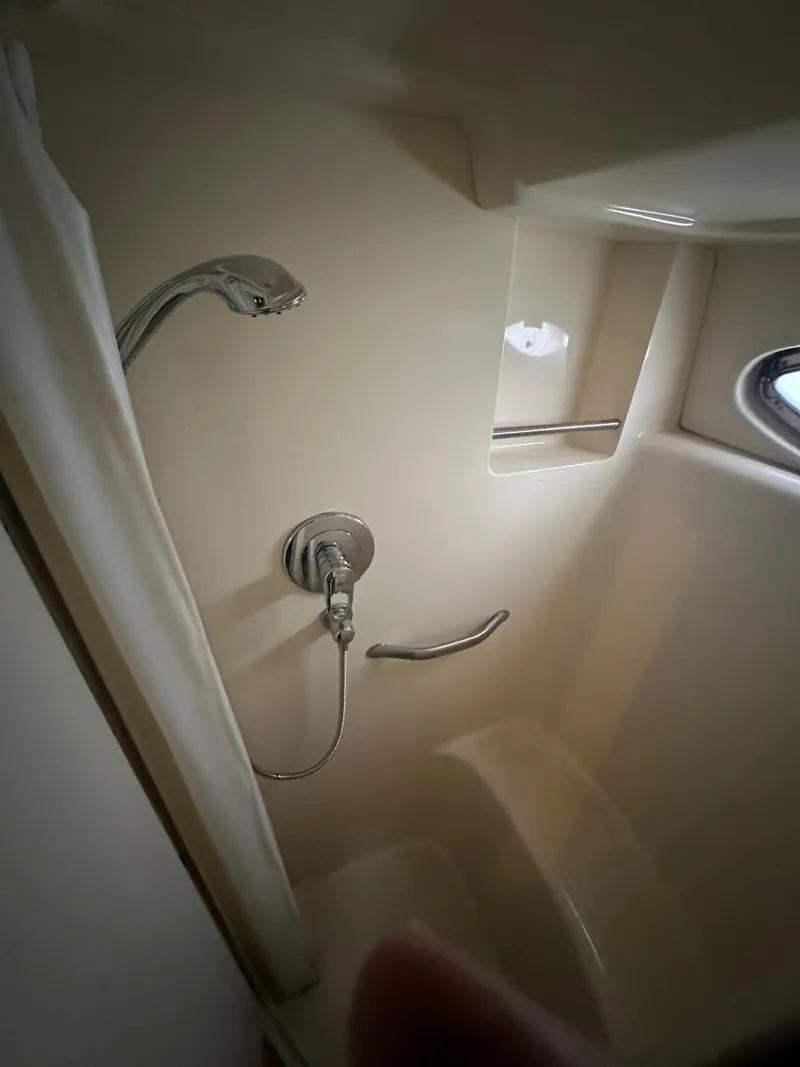 Slide: The Image of Shower area in 2004 Sea Ray 390 Motor Yacht with modern fixtures and porthole window. - 12