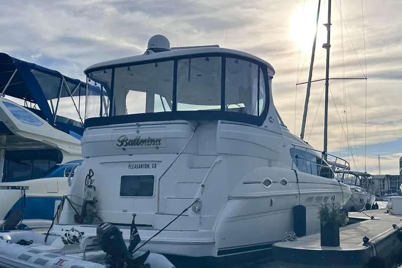 Slide: The Image of 2004 Sea Ray 390 Motor Yacht docked at marina under cloudy sky. - 20