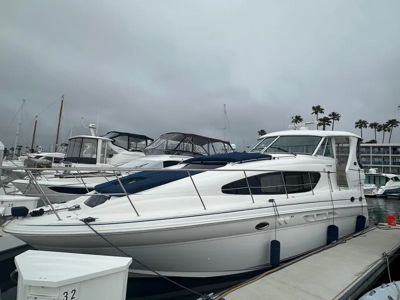Slide: The Image of 2004 Sea Ray 390 Motor Yacht docked at marina under cloudy skies. - 3