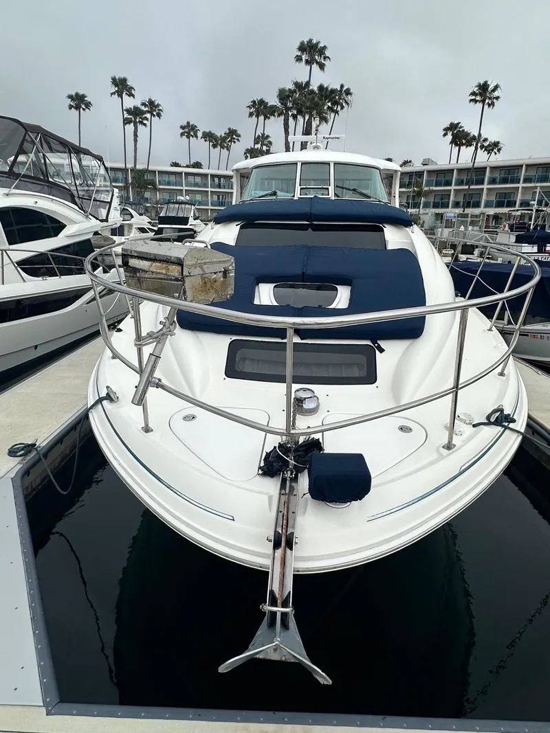 Slide: The Image of 2004 Sea Ray 390 Motor Yacht docked, featuring sleek design and spacious deck. - 4