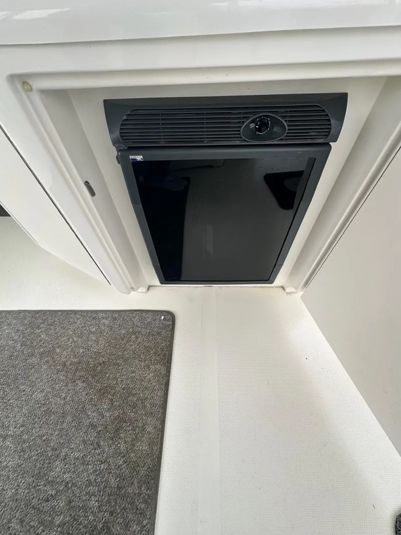 Slide: The Image of 2004 Sea Ray 390 Motor Yacht interior with compact black refrigerator. - 6