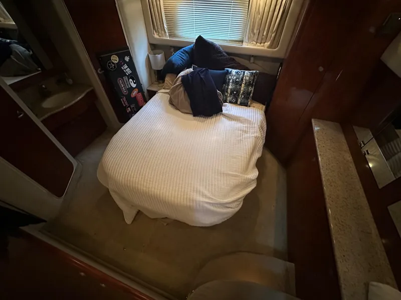 Slide: The Image of 2004 Sea Ray 390 Motor Yacht bedroom with cozy bed and pillows. - 9