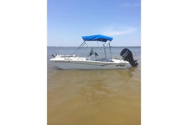 The Image of 2019 Mako Pro Skiff 15 CC boat on trailer with blue canopy. - 0