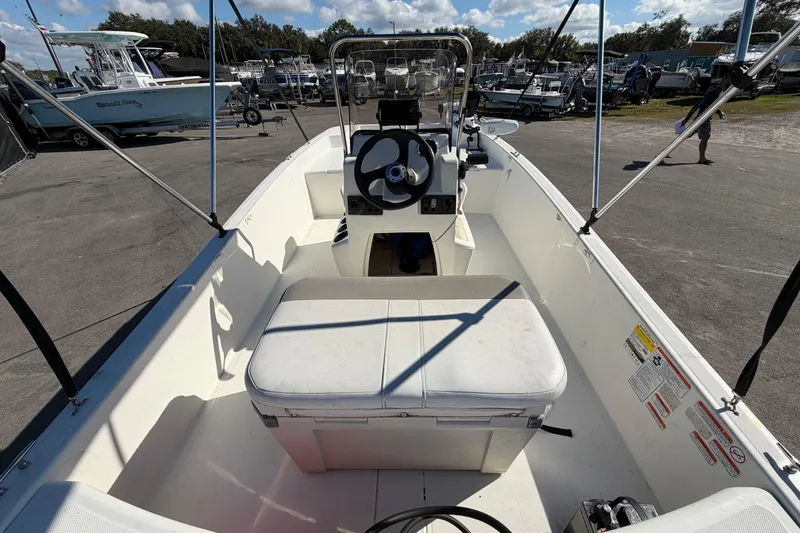 Slide: The Image of 2019 Mako Pro Skiff 15 CC boat on trailer, under blue sky. - 11
