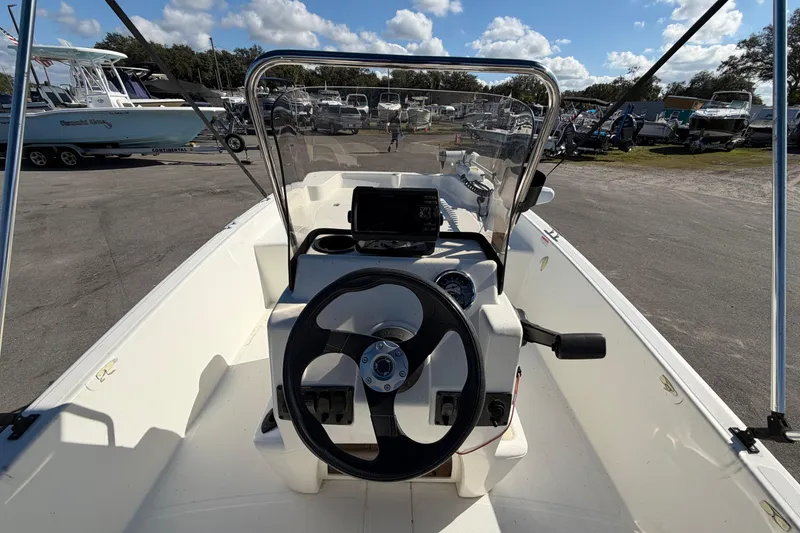Slide: The Image of 2019 Mako Pro Skiff 15 CC boat interior with steering console and seating. - 12