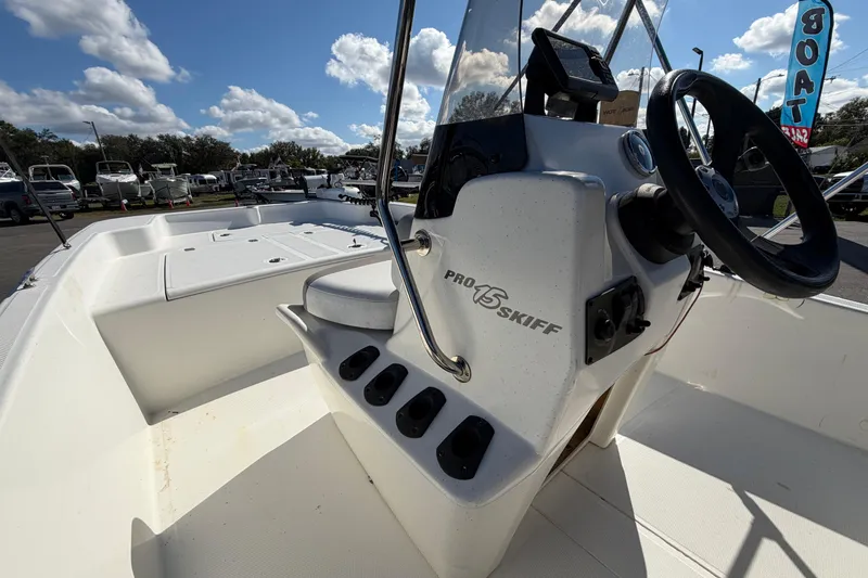 Slide: The Image of 2019 Mako Pro Skiff 15 CC interior with steering console and seating. - 18