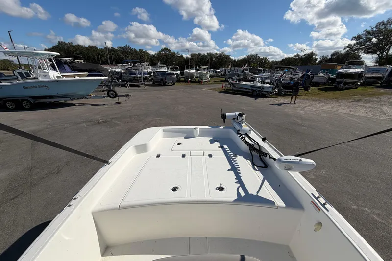 Slide: The Image of 2019 Mako Pro Skiff 15 CC boat console with steering wheel and controls. - 19