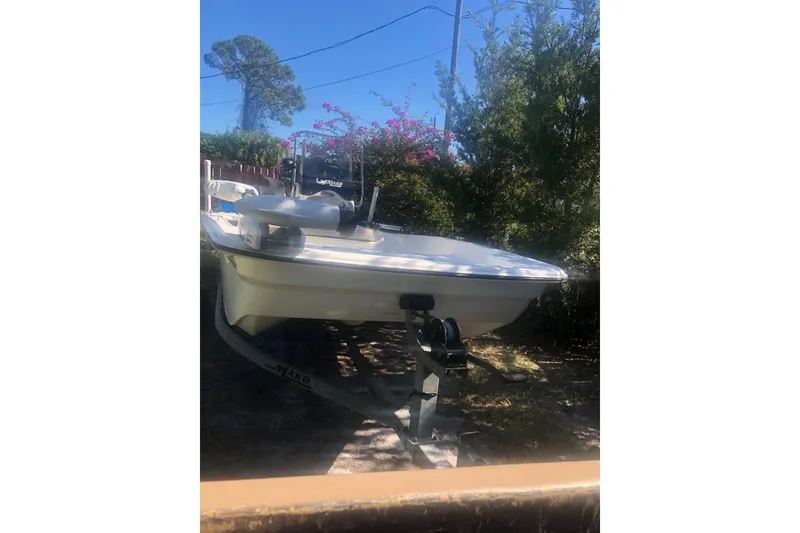 Slide: The Image of 2019 Mako Pro Skiff 15 CC boat with Mercury engine and blue canopy. - 2