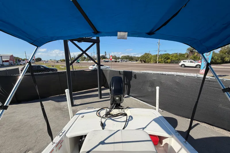 Slide: The Image of 2019 Mako Pro Skiff 15 CC storage compartment with battery and orange box. - 28