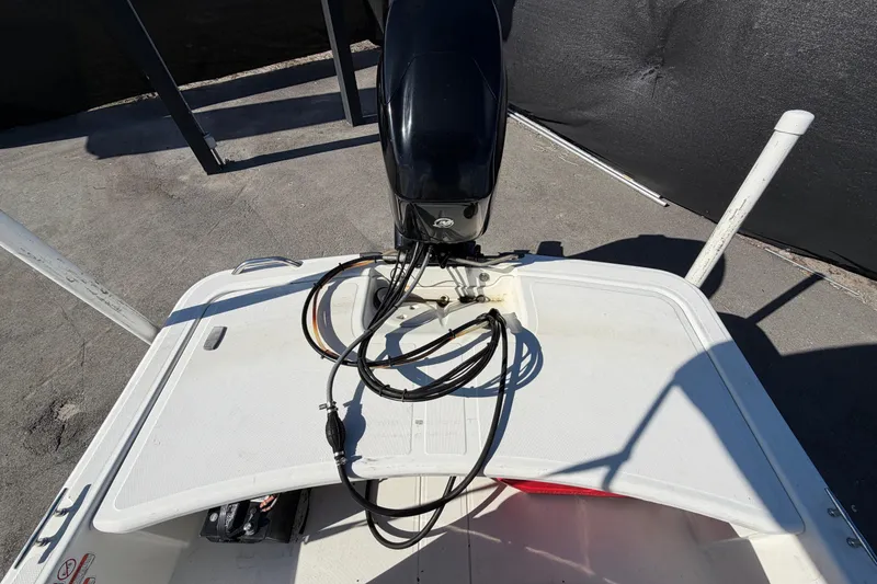 Slide: The Image of 2019 Mako Pro Skiff 15 CC boat with canopy, parked on pavement. - 33