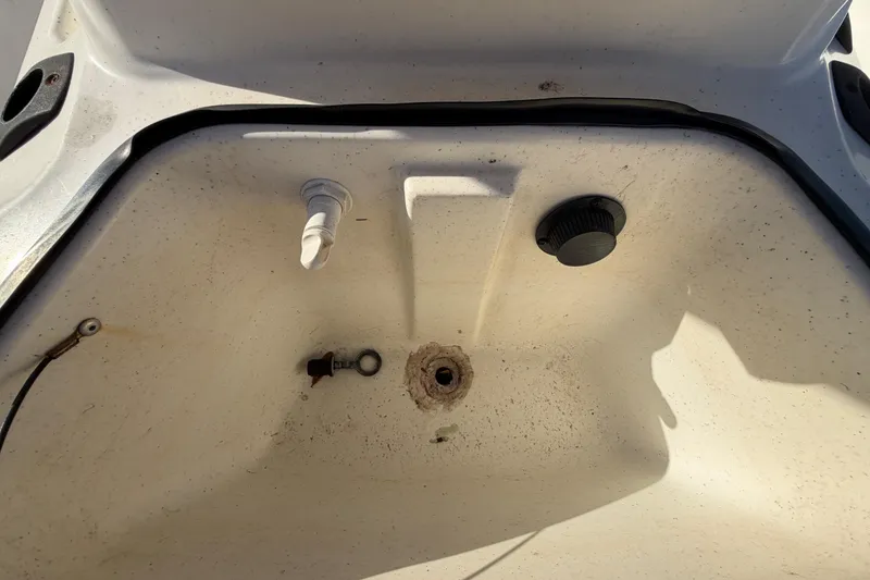 Slide: The Image of 2019 Mako Pro Skiff 15 CC interior compartment with fittings and drain plug. - 37