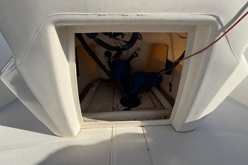 Slide: The Image of 2019 Mako Pro Skiff 15 CC storage compartment with wiring and equipment inside. - 38