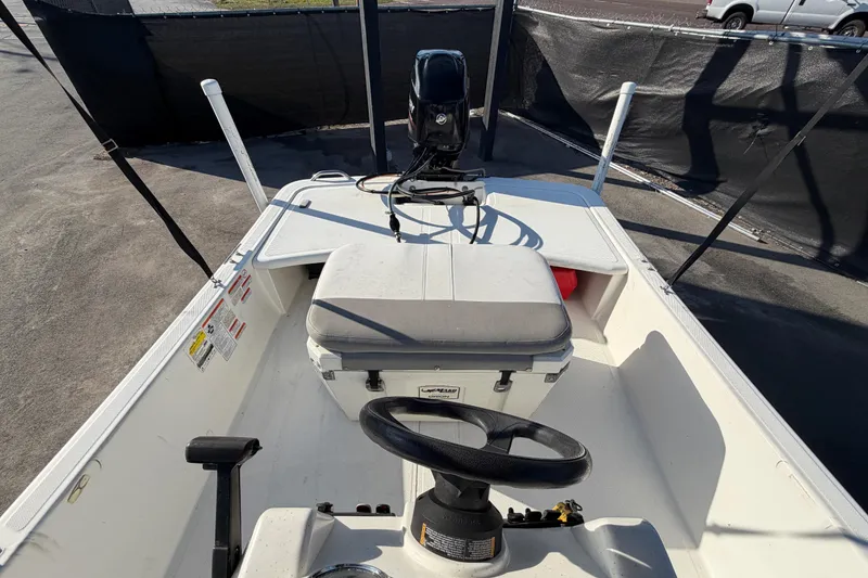 Slide: The Image of 2019 Mako Pro Skiff 15 CC boat interior with steering wheel and seating. - 39