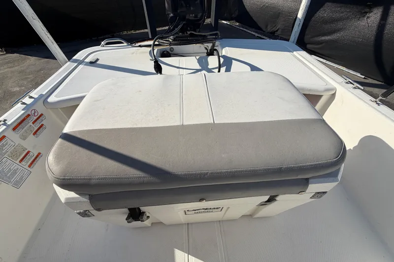 Slide: The Image of 2019 Mako Pro Skiff 15 CC boat interior with cushioned seating and storage. - 40