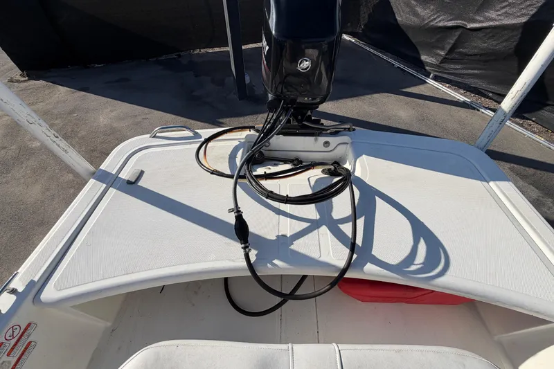Slide: The Image of 2019 Mako Pro Skiff 15 CC boat with outboard motor, docked on a sunny day. - 42
