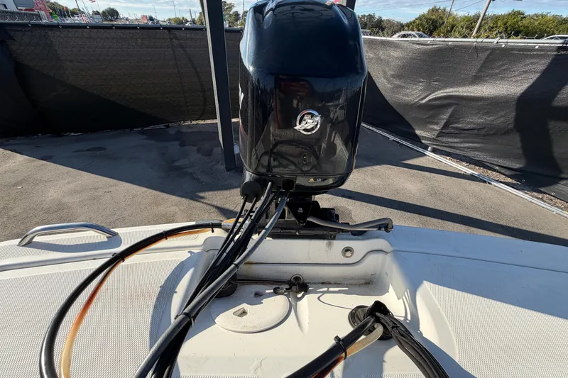 Slide: The Image of 2019 Mako Pro Skiff 15 CC boat with outboard motor in a parking area. - 43