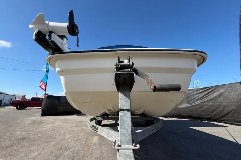 Slide: The Image of 2019 Mako Pro Skiff 15 CC boat with blue canopy on trailer. - 9