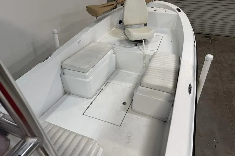 Slide: The Image of 2023 Panga 22 SPORT boat interior with white seating and storage compartments. - 17