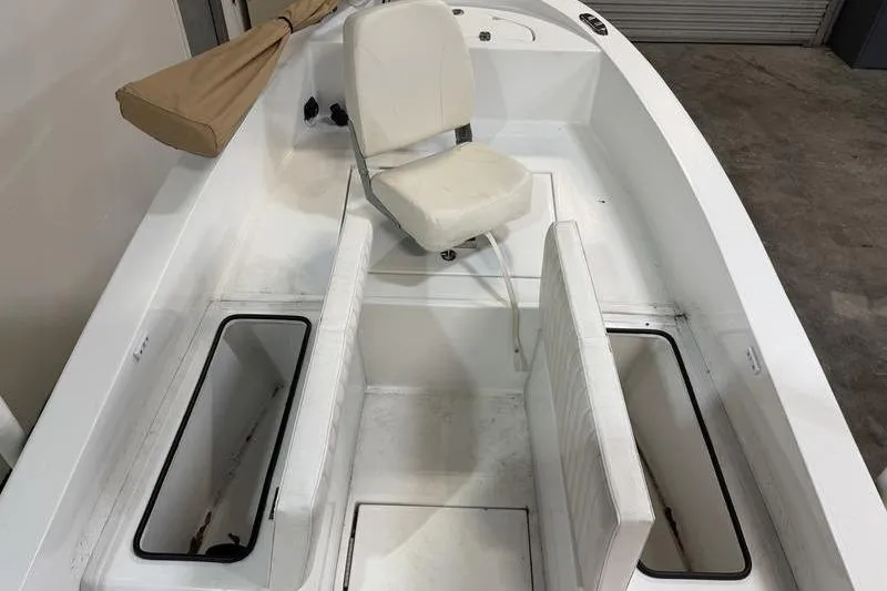 Slide: The Image of 2023 Panga 22 SPORT boat interior with white seating and storage compartments. - 18