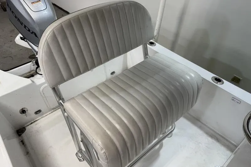Slide: The Image of 2023 Panga 22 SPORT boat seat with Honda engine in background. - 8