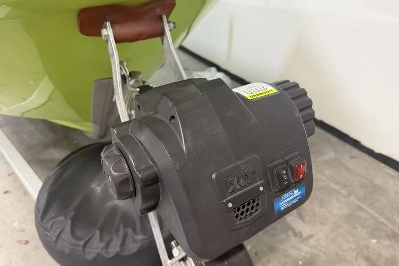 Slide: The Image of Close-up of a 2023 Panga 22 SPORT boat motor in a garage setting. - 4