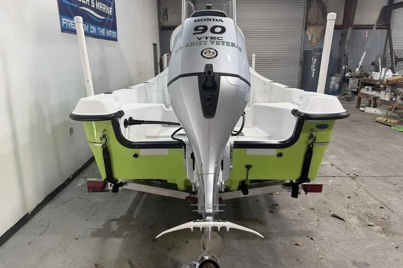 Slide: The Image of 2023 Panga 22 SPORT boat with Honda 90 VTEC engine in a workshop. - 6
