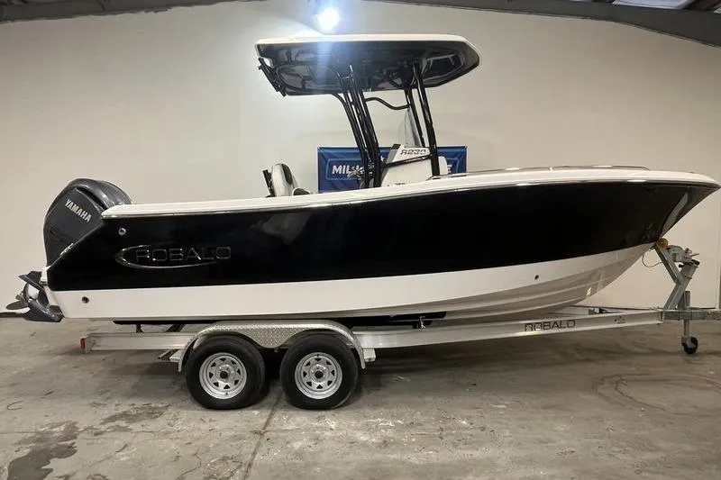The Image of 2023 Robalo R230 Center Console boat on trailer in showroom. - 1