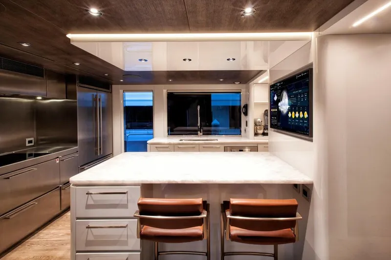Slide: The Image of Modern kitchen interior on 2018 Westport Raised Pilothouse yacht with waterfront view. - 12