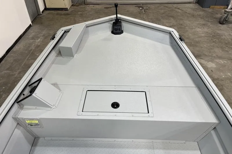 Slide: The Image of 2025 SeaArk 1860 MVJT boat interior with storage compartment and control panel. - 15