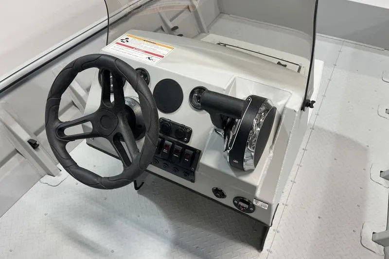 Slide: The Image of 2025 SeaArk 1860 MVJT boat console with steering wheel and controls. - 8