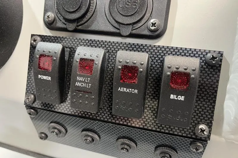 Slide: The Image of Control panel of 2025 SeaArk 1860 MVJT boat with switches for power, navigation, aerator, and bilge. - 9