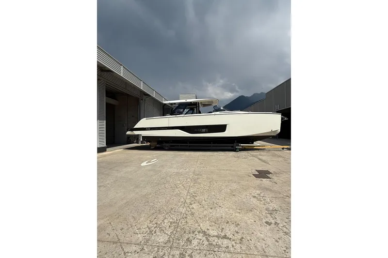 Slide: The Image of 2026 Cranchi A46 Luxury Tender yacht in a shipyard, under a cloudy sky. - 10