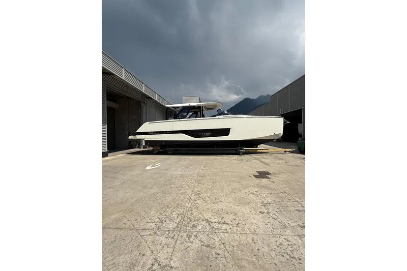 Slide: The Image of 2026 Cranchi A46 Luxury Tender yacht on dry dock under cloudy sky. - 11