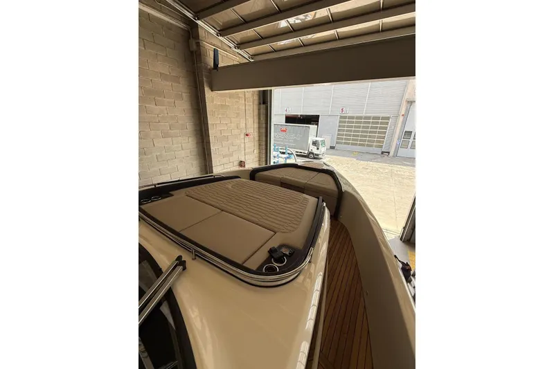 Slide: The Image of 2026 Cranchi A46 Luxury Tender in a garage, showcasing sleek design and spacious deck. - 14