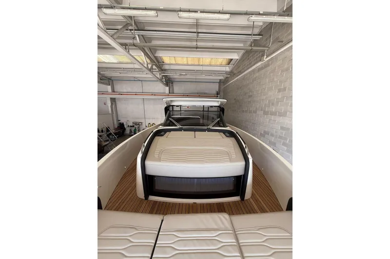 Slide: The Image of 2026 Cranchi A46 Luxury Tender in a garage, showcasing sleek design and spacious deck. - 15