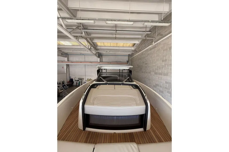 Slide: The Image of 2026 Cranchi A46 Luxury Tender in a modern indoor storage facility. - 17